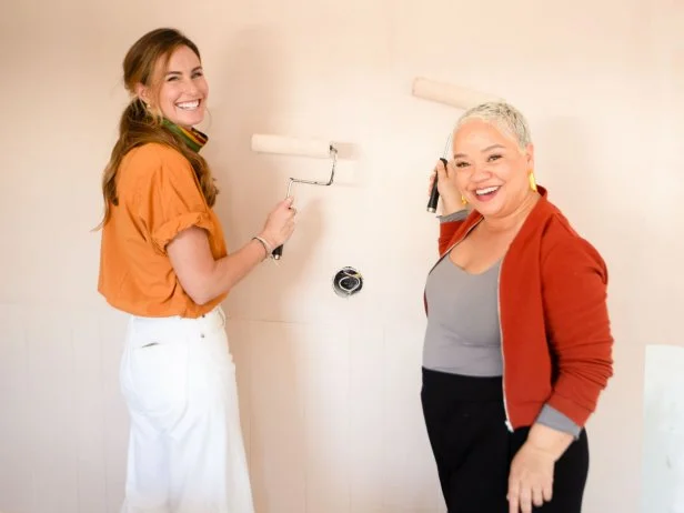Teammates Kim Wolfe and Kim Myles apply some paint during luxury suite renovations at the William and Garland hotel, as seen on 100 Day Hotel Challenge, Season 1.