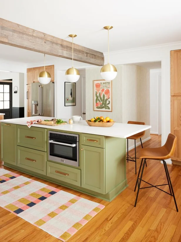 HGTV Magazine takes you inside this modern-rustic kitchen with a light green island, natural wood cabinets, wood beams and brass globe pendants.