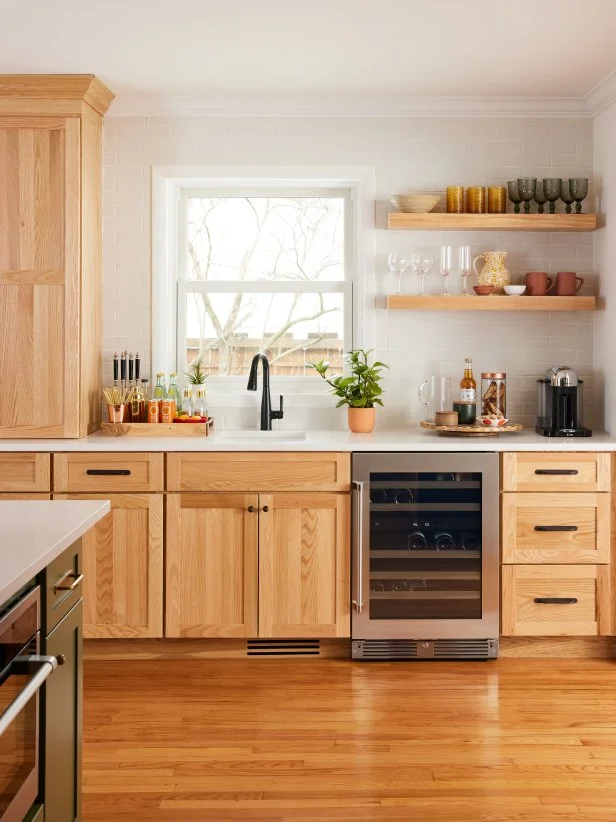 HGTV Magazine takes you inside this white kitchen with natural wood cabinets and a drink station with open shelves.