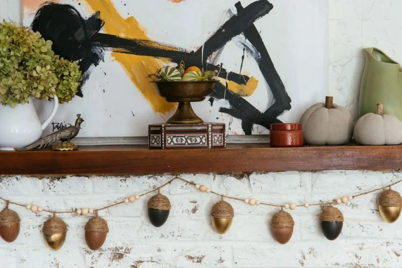 Garland of Acorns made of plastic easter eggs hangs from a mantle