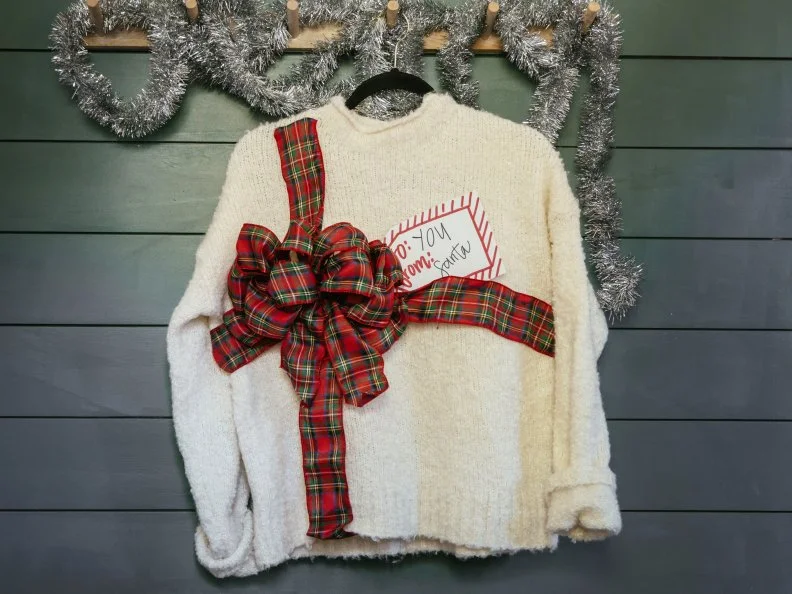 This adorable and easy to DIY Christmas sweater comes together with just some ribbon and a paper tag.