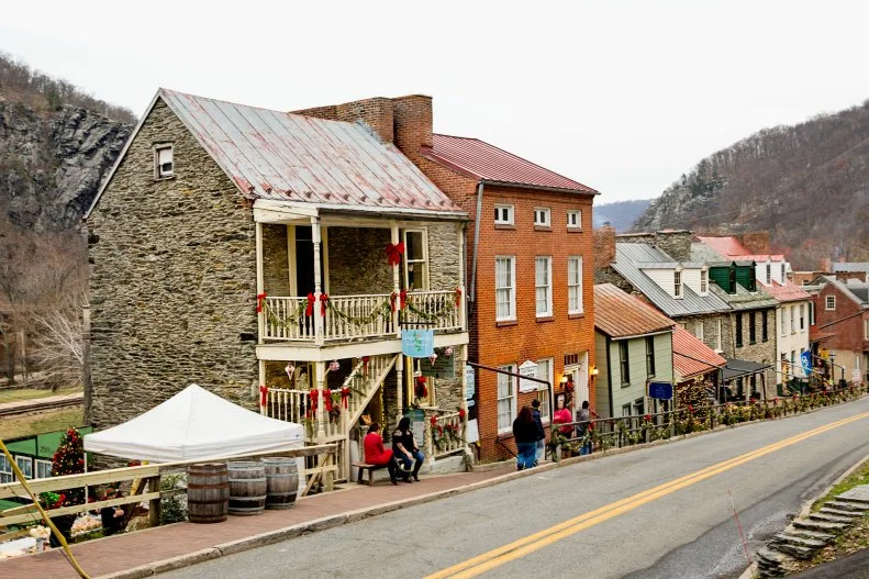 You don't need dramatic light displays to get into the spirit of the holiday season. In Harpers Ferry, West Virginia little things mean a lot from the red bows decorating the old fashioned downtown to the garlands hung from handrails.