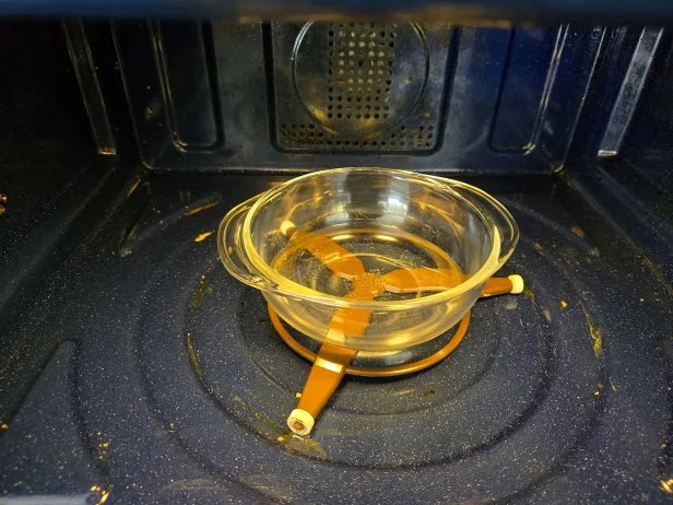 How to clean a microwave with a bowl of white vinegar.