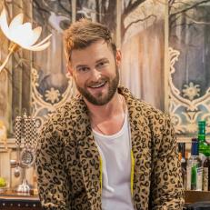 Bobby Berk poses for a photo in the newly renovated media room belonging to collector Hailie Lidow, as seen on Junk or Jackpot, season one.