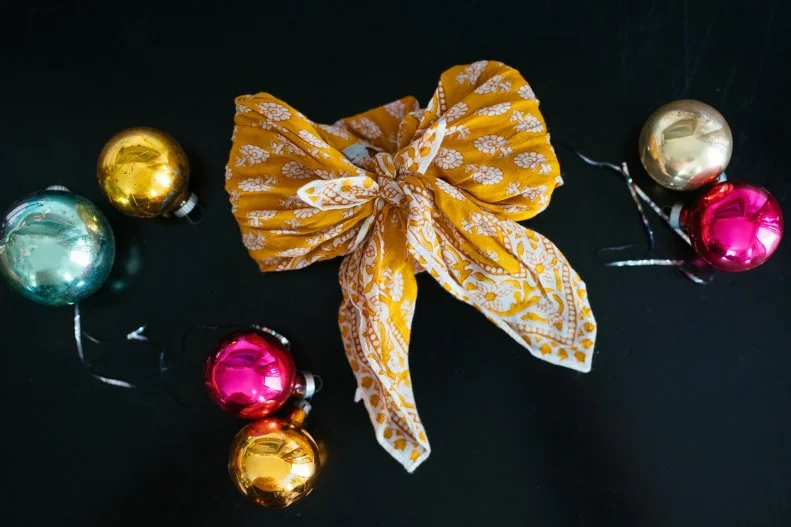 Tie up a gift card with a pretty bow made from a scarf or bandana.