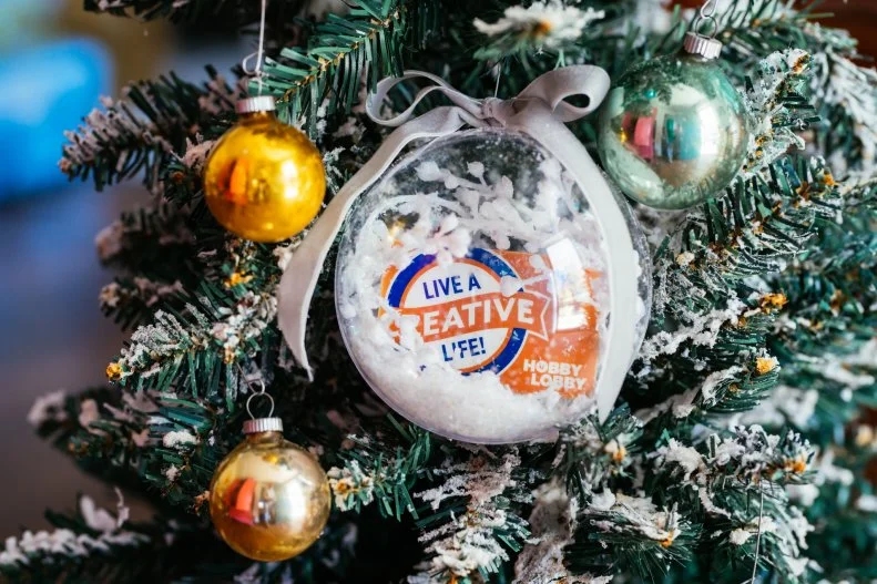 A clear plastic Christmas ornament is a beautiful way to make a gift cad feel extra special.