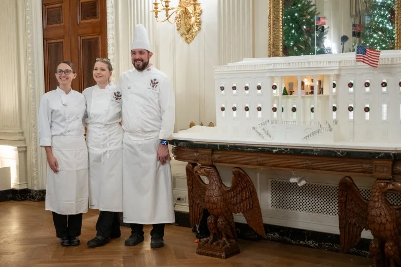 The 2025 White House gingerbread house decorated with royal icing and pastillage (a type of sugar paste that becomes hard and durable when dry) is displayed in the State Dining Room and depicts the South Portico.