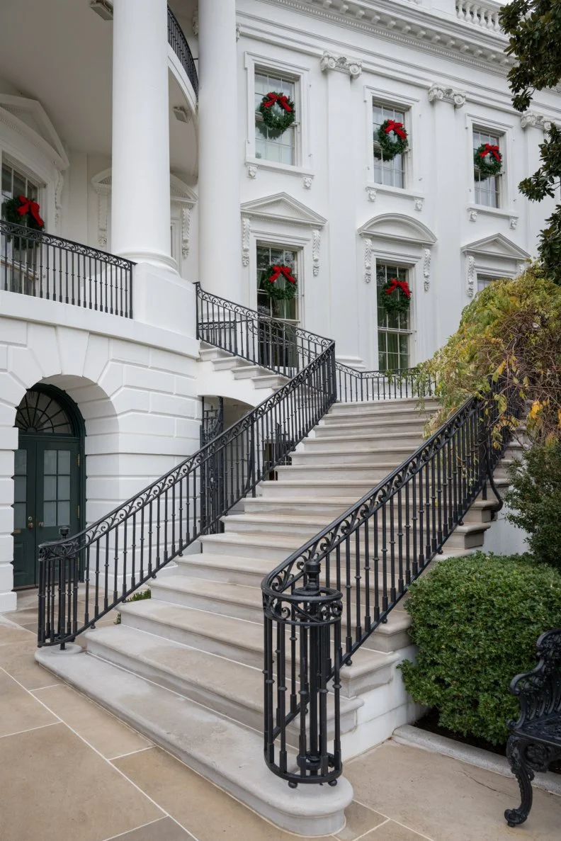 In 1800 the first president to take residence in the freshly built White House was President John Adams. Today this grand neoclassical-style People's House at 1600 Pennsylvania Avenue in Washington, DC  represents the hopes and ambitions of Americans. Decked out for the holidays with festive green wreaths festooned with red bows, the sandstone walls painted white are even more resplendent.