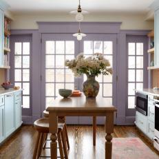 Blue and Purple Transitional Kitchen With Wood Table