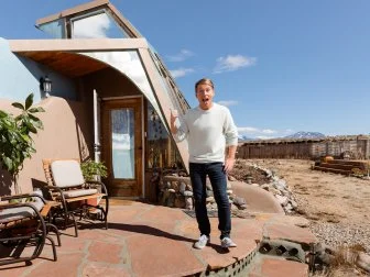 Host Jack McBrayer outside the Earthship Home, as seen on Zillow Gone Wild, Season 2.