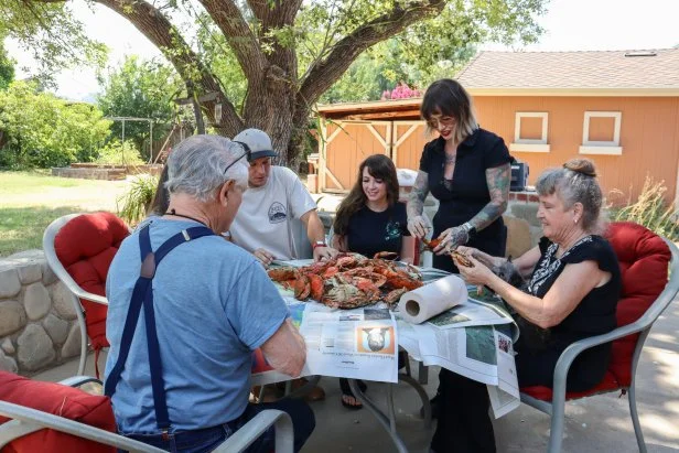 From left to right: Clockwise: Robert Grimes, Jack Tingelhoff, Megan Thompson, Robyn Farrell, and Jeanne Grimes enjoy a seafood boil in the backyard at Simi Sands, Hero, as seen on My Lottery Dream Home, Season 18.