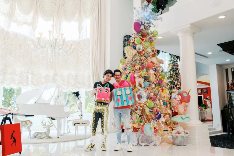 Frank Marino and Alex posing with the candyland Christmas tree, as seen on Hoarding for the Holidays, Season 1.