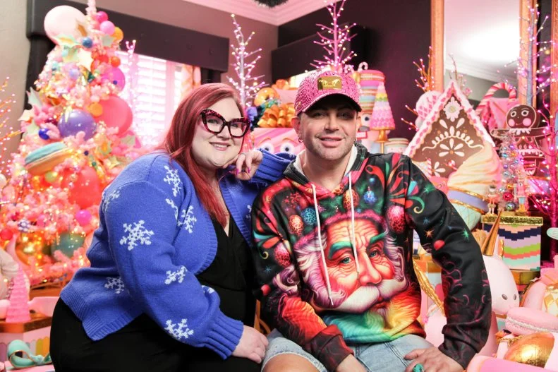 Bryan and Chelsea posing for a portrait in front of all the decorations, as seen on Holiday Hoarders, Season 1.