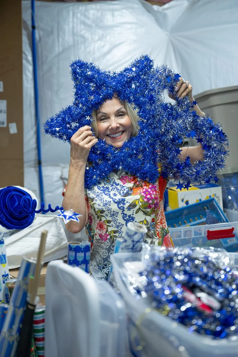 AUGUST 13, 2025: Flo Weinstein convinces daughters Laura and Tara to takeover her large Hanukkah collection of decorations, clothing, and festivities during her “Menorah Madness” party on August 13, 2025 in West Berlin, NJ.