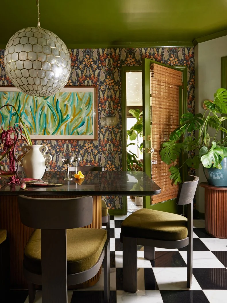 Green Dining Space With Floral Wallpaper and Checkered Floors