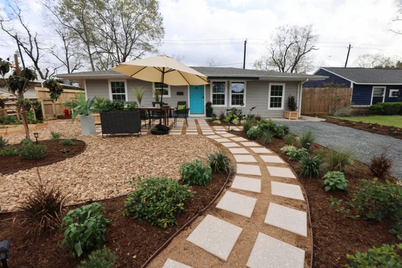 new fence, winding walkway, fresh landscaping and outdoor dining area