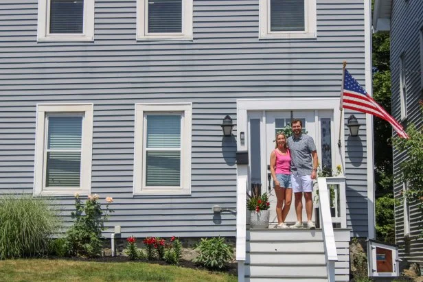 Danielle Moore (left) and John Field (right) pose for a picture by the front door of their home, as seen on MLDH: Where Are They Now.