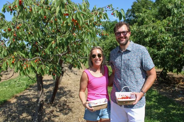 Danielle Moore (left) and John Field (right) pose for a picture while picking cherries, as seen on MLDH: Where Are They Now.