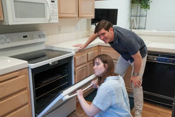 Agoura Hills, CA, Emilie and Antonio are in the kitchen examining the new oven with electric stovetop, as seen on House Hunters, Season 273.