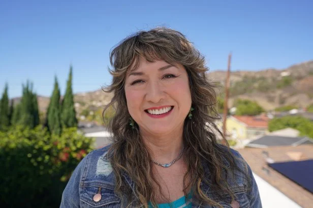 Andromeda is all smiles, while enjoying some sunshine outside one of the houses, Agoura Hills, CA, as seen on House Hunters, Season 273.