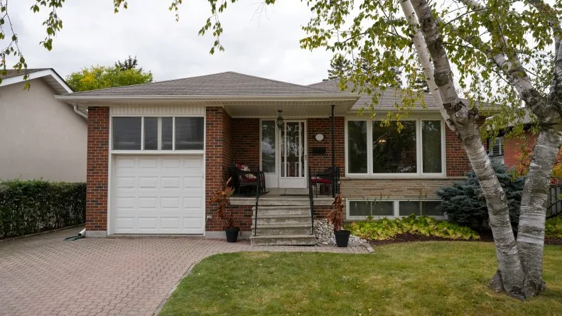 The front porch and broken garage door are just the problems visible from the curb at Mike and Janetta's house.