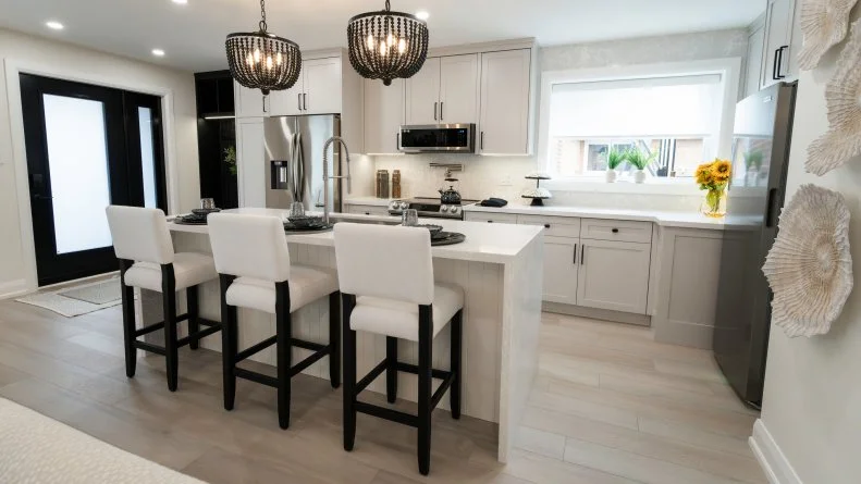 With the wall that divided the main living space gone, the house now flows from entry through kitchen to dining.  Natural light abounds.