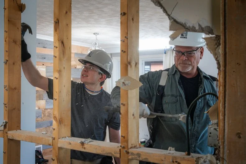 Superfan Michael works on demolition with his hero Mike Holmes.