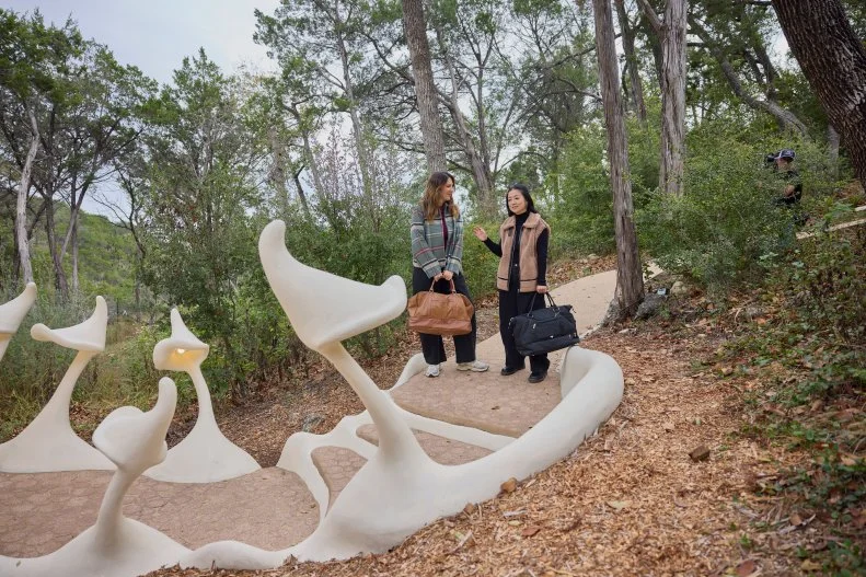 Host Sherry Cola and D’Arcy Carden walk to the entry of the Bloomhouse, as seen on Wild Vacation Rentals, Season 1.