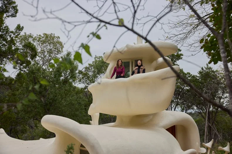Host Sherry Cola and D’Arcy Carden in the Exterior Balcony of the Bloomhouse, as seen on Wild Vacation Rentals, Season 1.