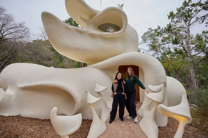 Host Sherry Cola and D’Arcy Carden at the Exterior Entry of the Bloomhouse, as seen on Wild Vacation Rentals, Season 1.