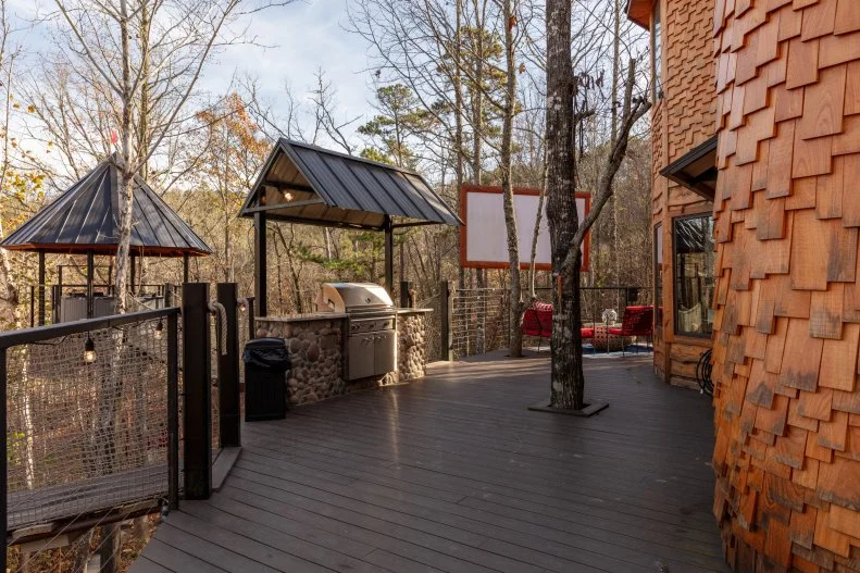 the grill, hot tub and home theater at Treetopia in Broken Bow