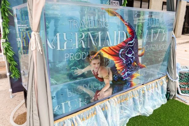 Megan in mermaid costume in tank swimming , as seen on Extreme Buyers Club, Season 1.