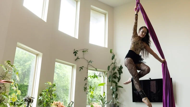 Client Anastasia practicing her aerial silks at home, as seen on Extreme Buyers Club Season 1