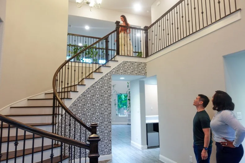 Host Noel Collier, and Mark seeing Anastasia come down the stairs, as seen on Extreme Buyers Club, Season 1.