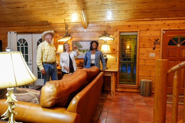 Host Noel Collier, Rhonda, and Steve looking around the house during house tour, as seen on Extreme Buyers Club, Season 1.