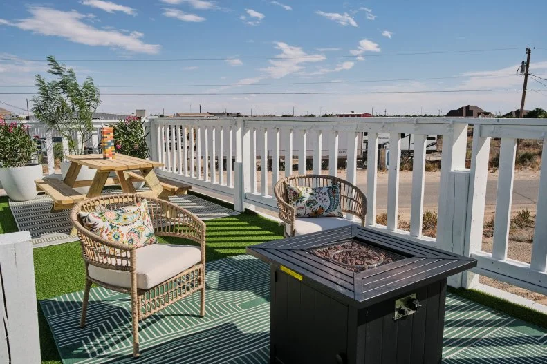 The outside deck with games and chairs made to look like a wing on a finished airplane house, as seen on Extreme Buyers Club, Season 1.
