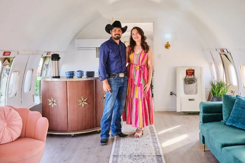 (left to right) Clients Ismael and Ruth Lara pose for a photo in the finished airplane house, as seen on Extreme Buyers Club, Season 1.