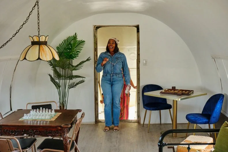 Host Noel Collier walks into the finished airplane house for the first time, as seen on Extreme Buyers Club, Season 1.
