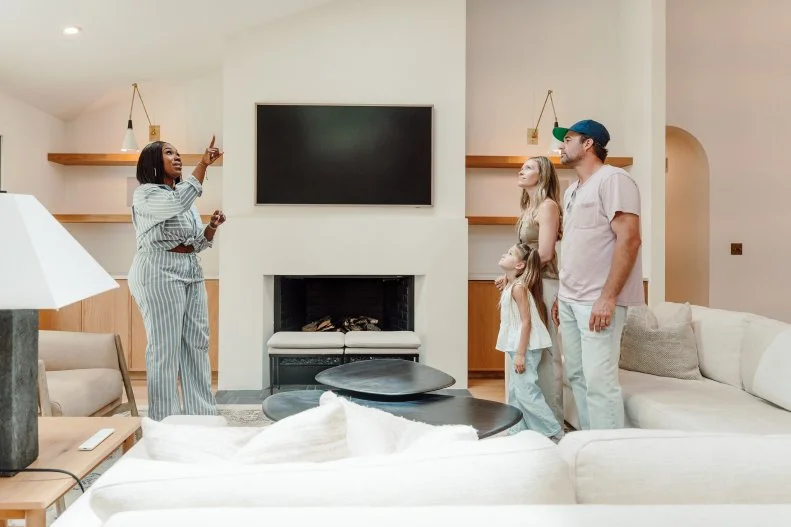 Host, Noel Collier and clients Aaron Ross and Bethany Ross, walking through the house, as seen on Extreme Buyers Club, Season 1.