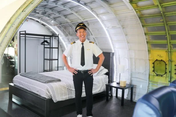 Host Jack McBrayer with the bed at the Infinite Skies house, as seen on Zillow Gone Wild, Season 3.