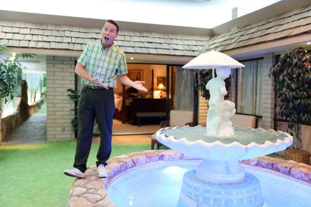 Host Jack McBrayer and a fountain at the Best Kept Secret house, as seen on Zillow Gone Wild, Season 3.