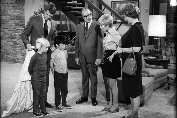 UNITED STATES - MARCH 06:  THE BRADY BUNCH - "To Move or Not to Move" - Season One - 3/6/70, Cindy (Susan Olsen, left) and Bobby (Mike Lookinland, third from left) dressed as ghosts to scare away perspective buyer, Mrs. Hunsaker (Fran Ryan), after Mike (Robert Reed, left) and Carol (Florence Henderson) decided to sell the house. The man in the center is unidentified.,  (Photo by ABC Photo Archives/Disney General Entertainment Content via Getty Images)