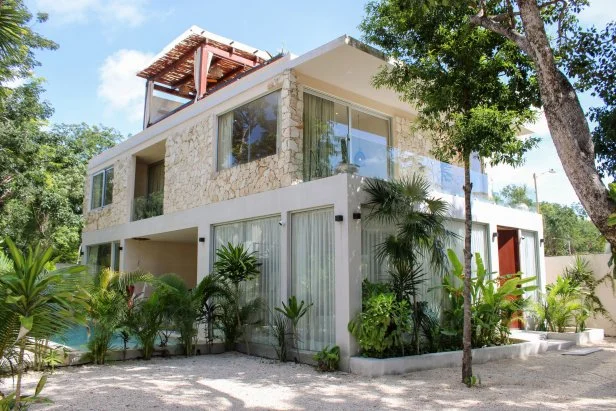 Exterior shot of modern suburban home during Akhil Patel and Amy Leong's house tour, as seen on Tropic Like It's Hot, Season 1.