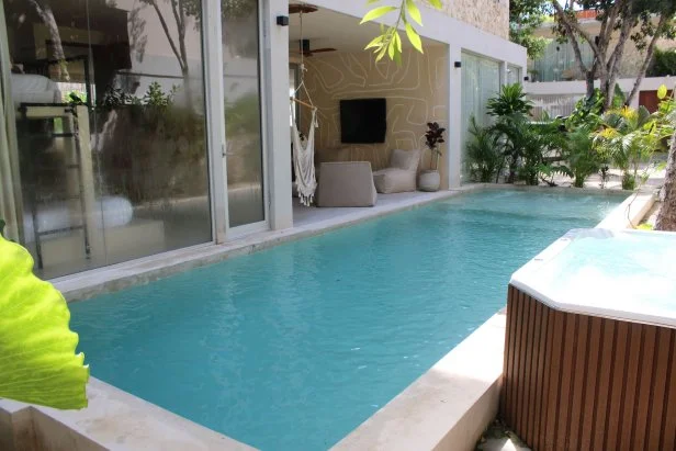 Exterior shot of pool in modern suburban home during Akhil Patel and Amy Leong's house tour, as seen on Tropic Like It's Hot, Season 1.