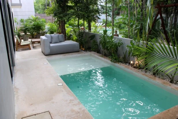 Exterior shot of pool in modern compact home during Gabby Tomasello and Megan Weintraub's house tour, as seen on Tropic Like It's Hot, Season 1.