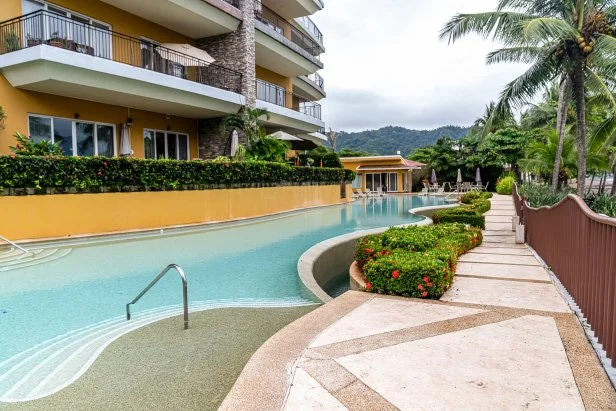 Exterior shot of pool in modern condo during Jessie McNeill and Matt Lavery's house tour, as seen on Tropic Like It's Hot, Season 1.