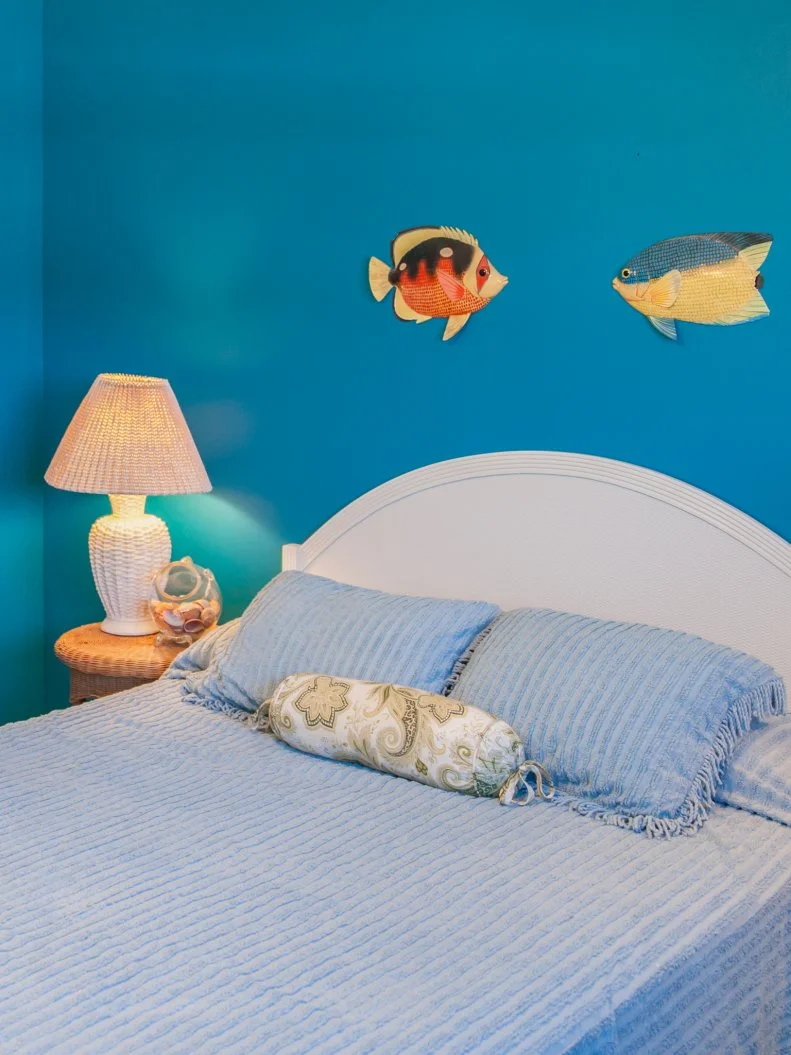 As seen on Beach Flip, before renovations, the front guest bedroom on the second floor of the Coastal Calm condo lacks design detail and has very outdated furniture. (Before 142)