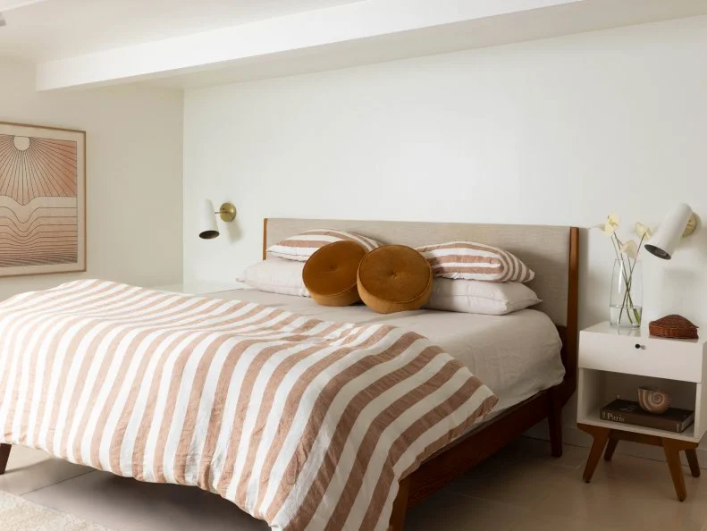 White Bedroom With Striped Bedding and Minimal Decor