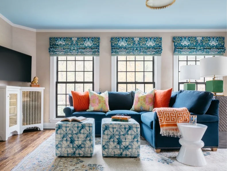 Blue Living Room With Navy Sectional and Colorful Decor