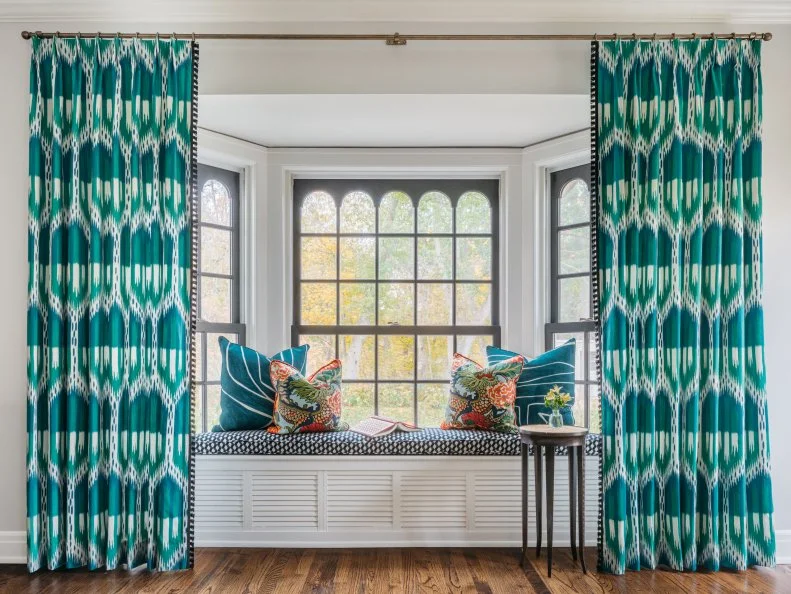 Bay Window With a Built-In Bench Seat and Bold Drapery